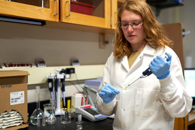 Heather Ricker, a ¼ϲʿ student, drops nitrogen in a test tube in a chemistry lab