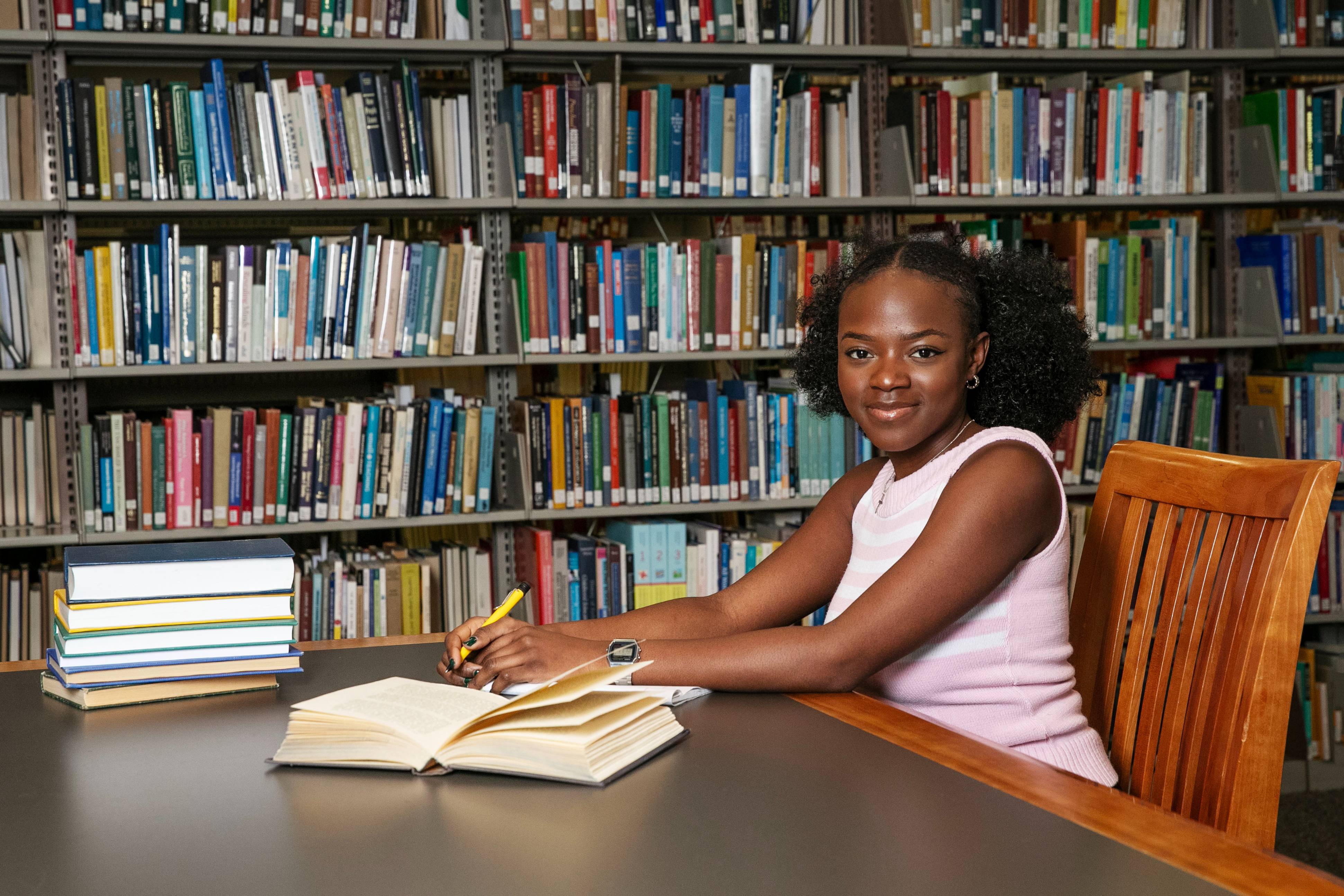 A photo of me, Anesu Mukombiwa ’24, in ¼ϲʿ’s Scribner Library, doing what I love: writing. 